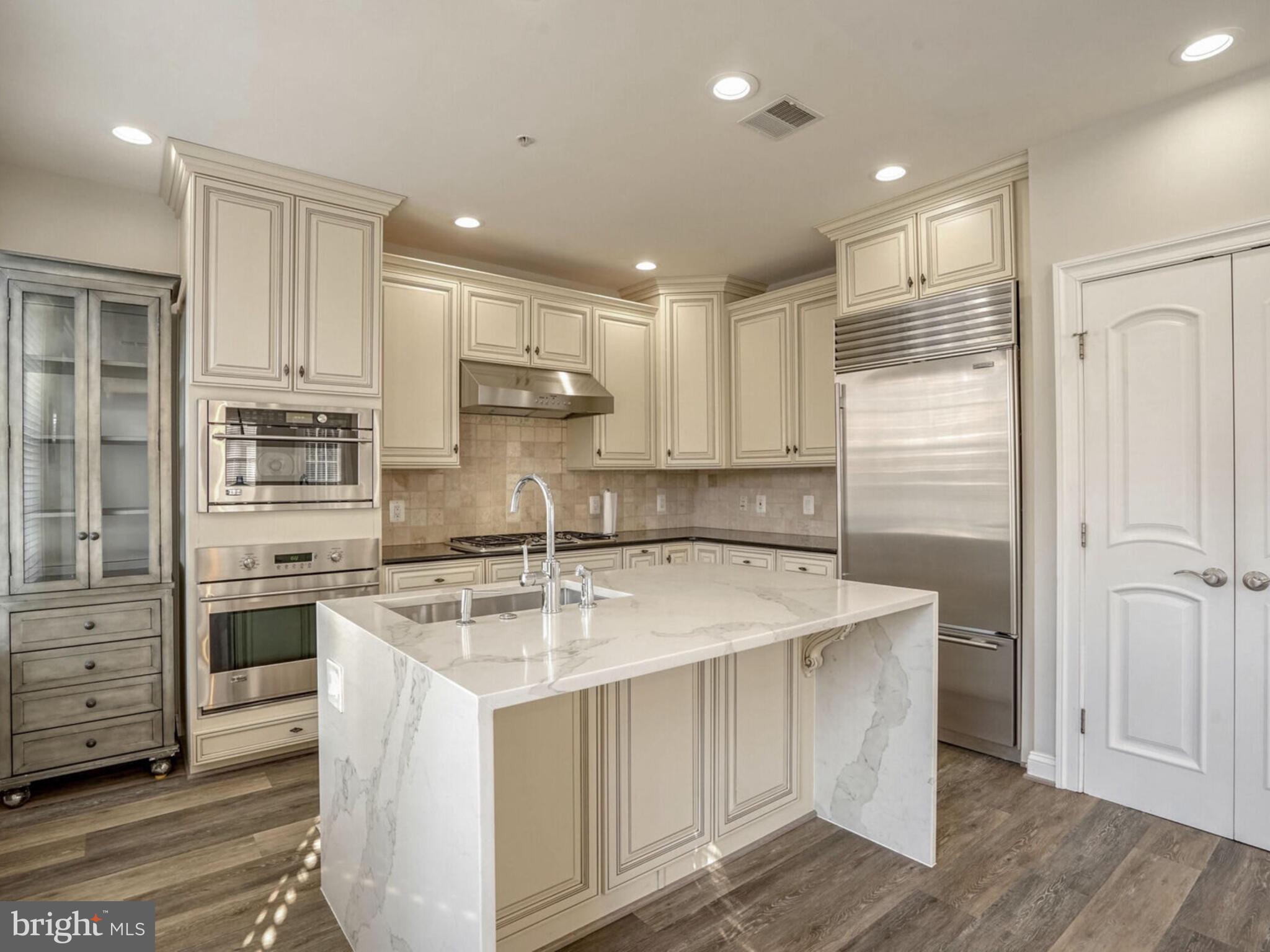 1781 Chain Bridge Road, Unit 307 McLean, VA 22102 - Photo 13 of 18 a kitchen with stainless steel appliances granite countertop a sink stove and refrigerator