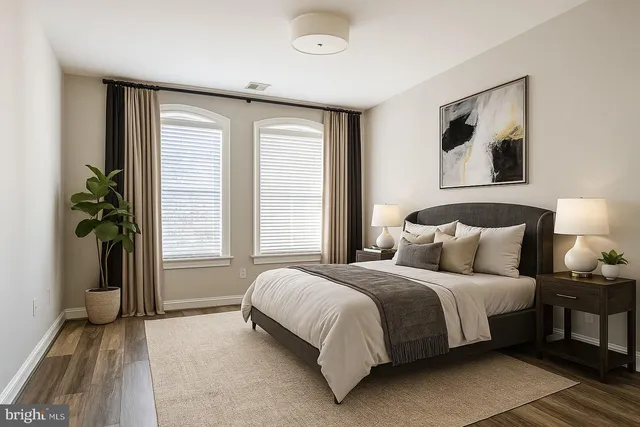 a bedroom with a bed and a potted plant