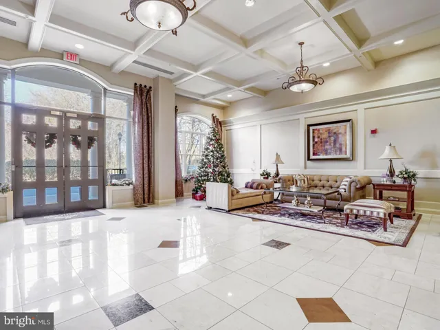 a living room with furniture and large windows