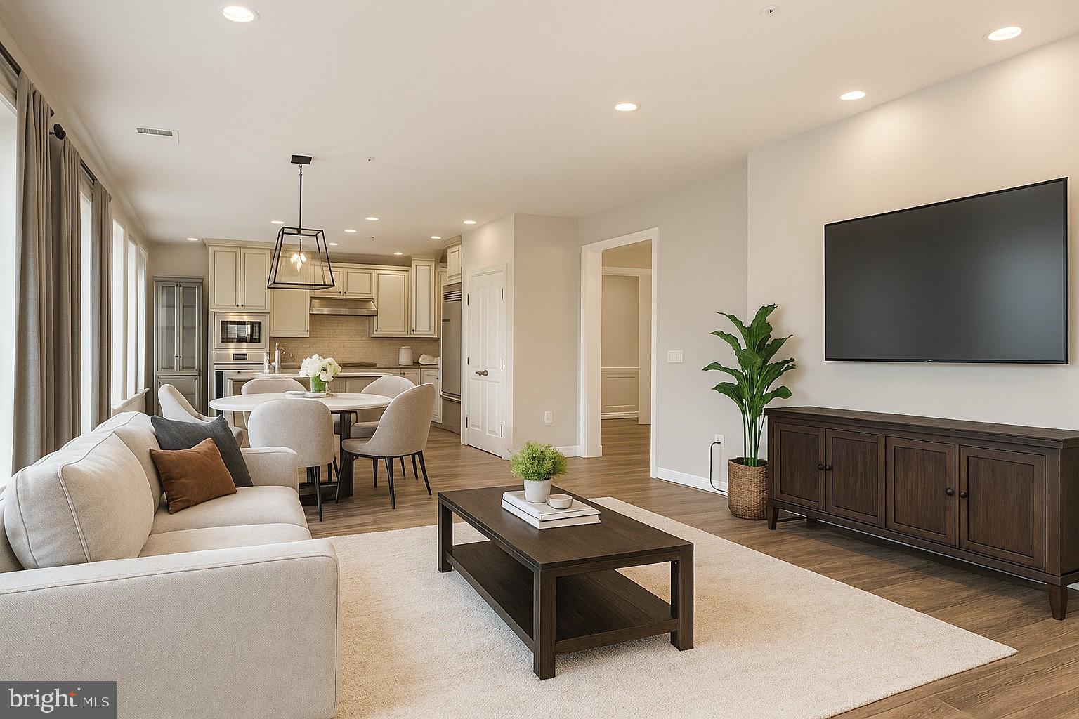1781 Chain Bridge Road, Unit 307 McLean, VA 22102 - Photo 9 of 18 a living room with furniture kitchen view and a flat screen tv