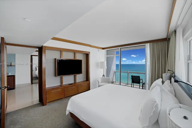 a bed room with a bed and a television