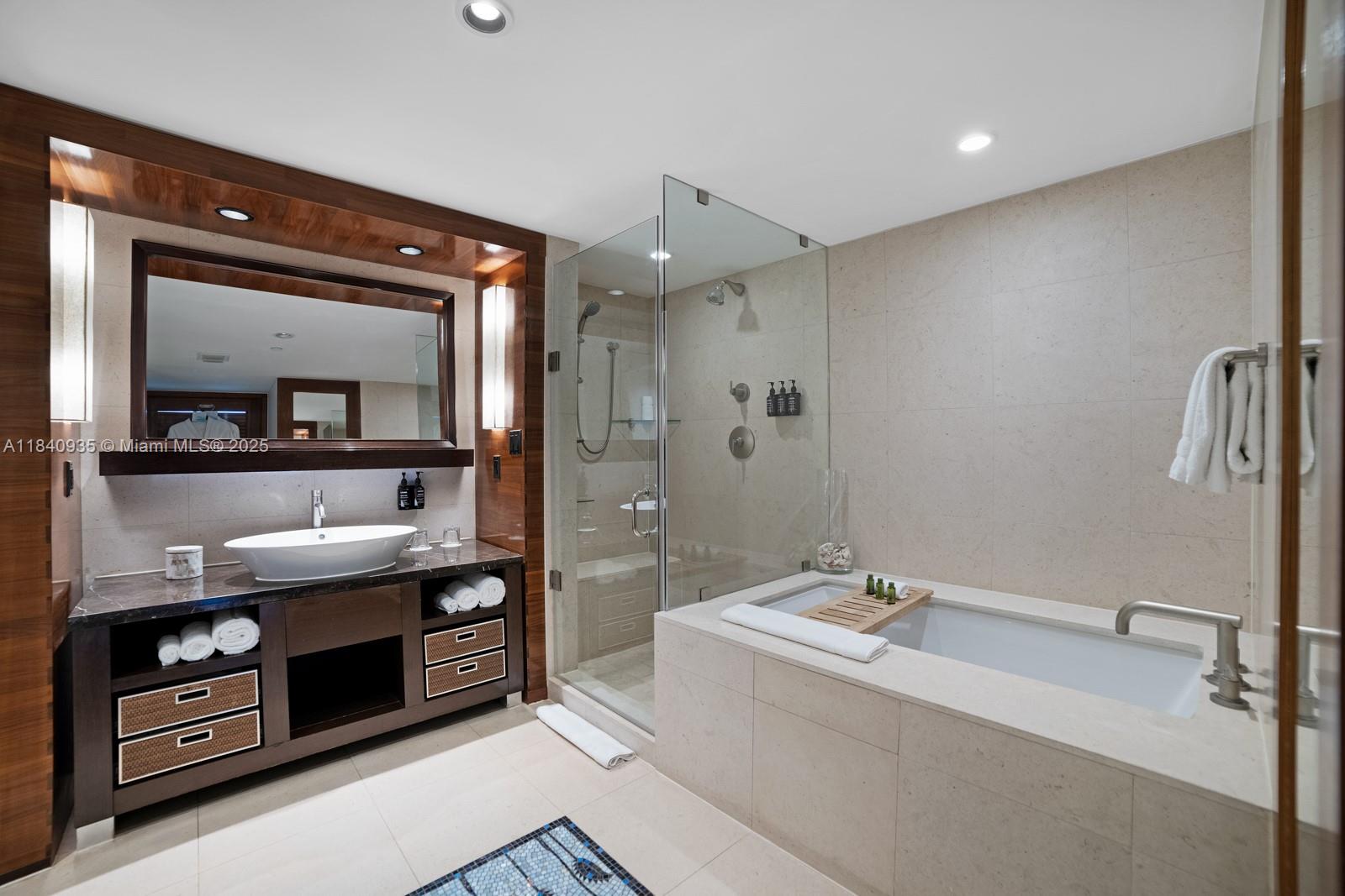 6801 Collins Avenue, Unit 705 Miami Beach, FL 33141 - Photo 13 of 54 a bathroom with a tub sink and mirror