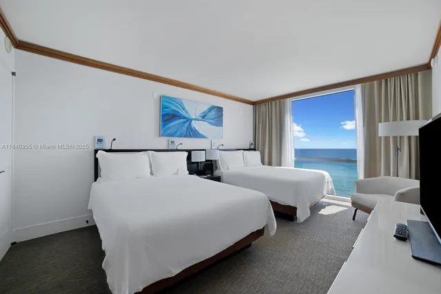 a bedroom with double bed and a window