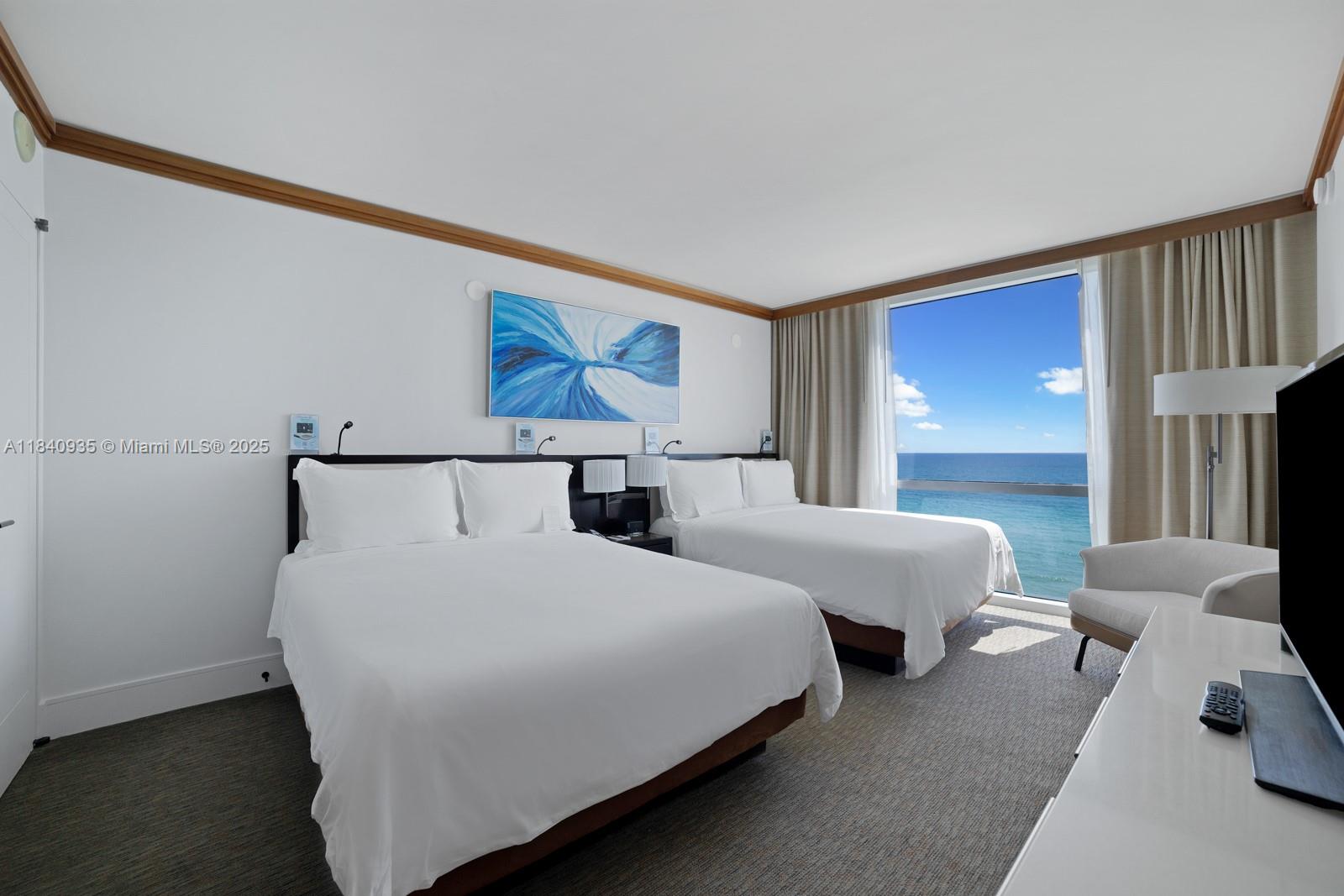 6801 Collins Avenue, Unit 705 Miami Beach, FL 33141 - Photo 16 of 54 a bedroom with double bed and a window