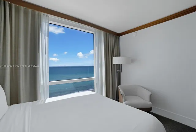 a bedroom with a bed and a lamp on table