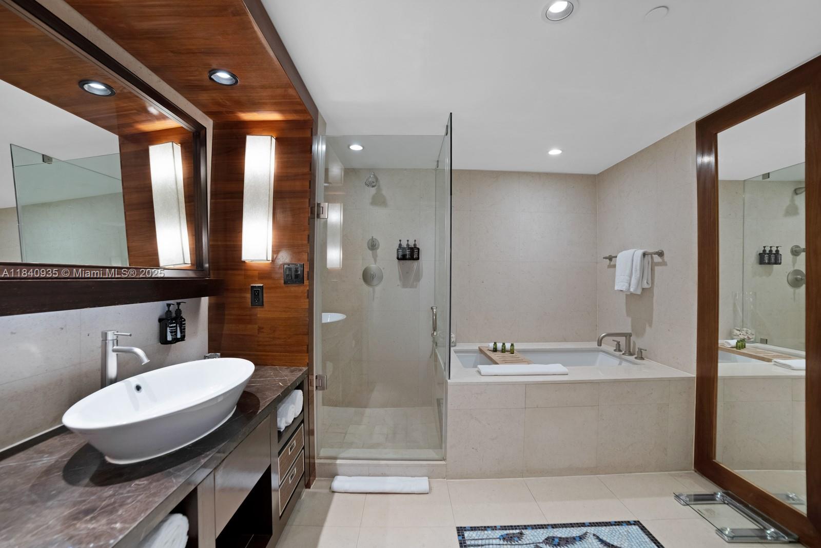 6801 Collins Avenue, Unit 705 Miami Beach, FL 33141 - Photo 19 of 54 a bathroom with a sink a toilet a mirror and shower