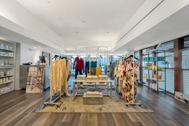 a spacious bedroom with a bed and a chandelier