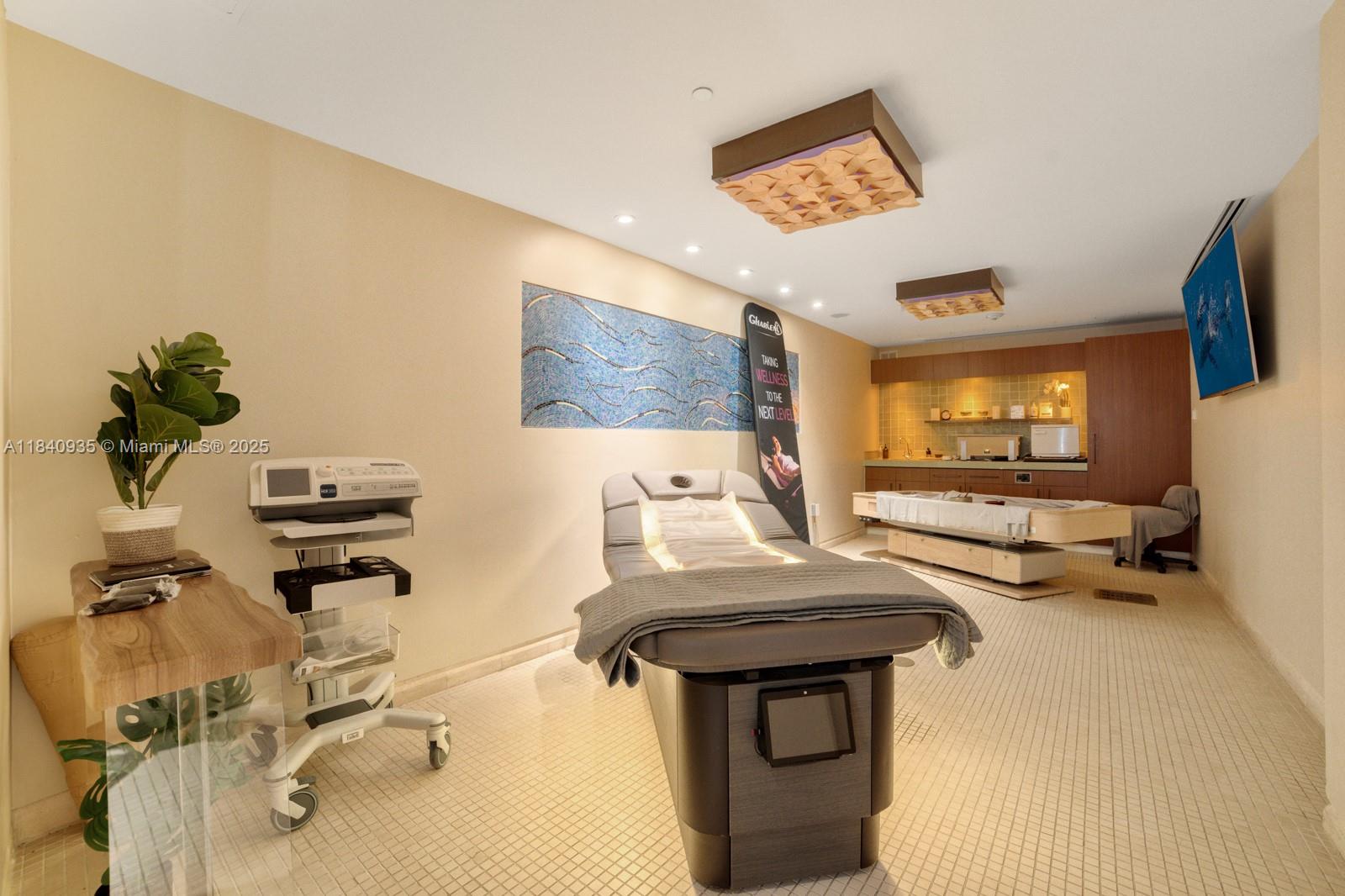 6801 Collins Avenue, Unit 705 Miami Beach, FL 33141 - Photo 37 of 54 a living room with furniture and a flat screen tv