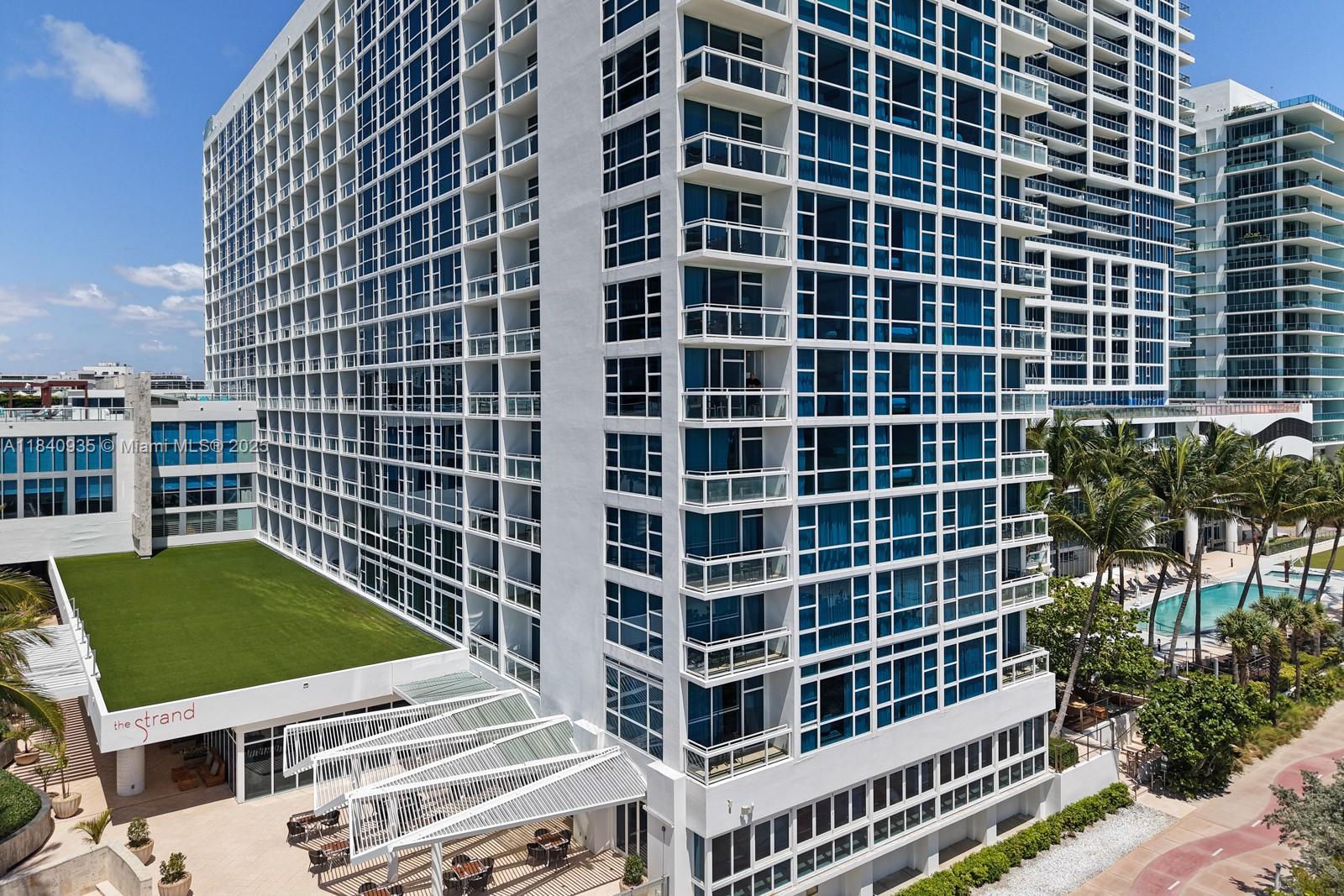 6801 Collins Avenue, Unit 705 Miami Beach, FL 33141 - Photo 41 of 54 a view of a building with a yard