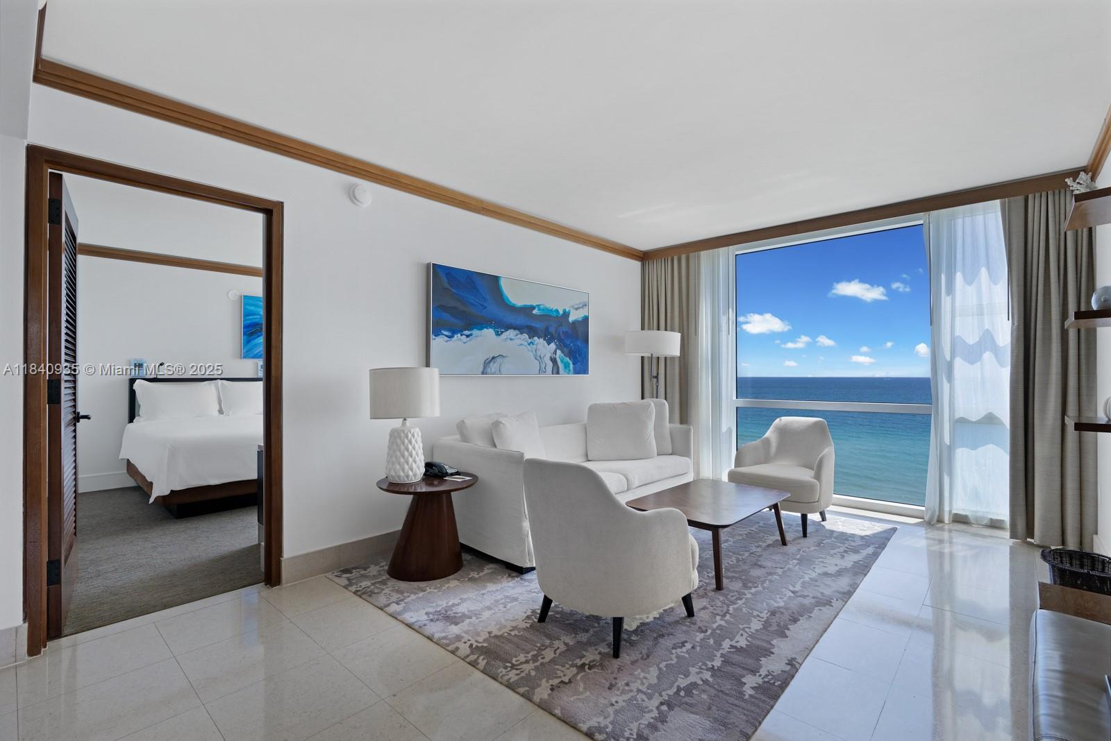 6801 Collins Avenue, Unit 705 Miami Beach, FL 33141 - Photo 5 of 54 a living room with furniture and a large window