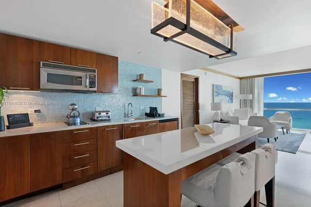 a kitchen with a stove a sink a dining table and chairs