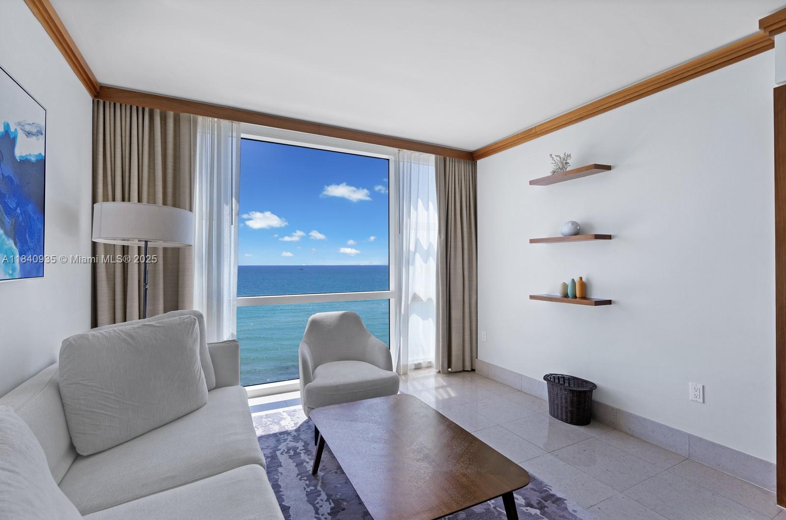 6801 Collins Avenue, Unit 705 Miami Beach, FL 33141 - Photo 8 of 54 a living room with furniture and a window