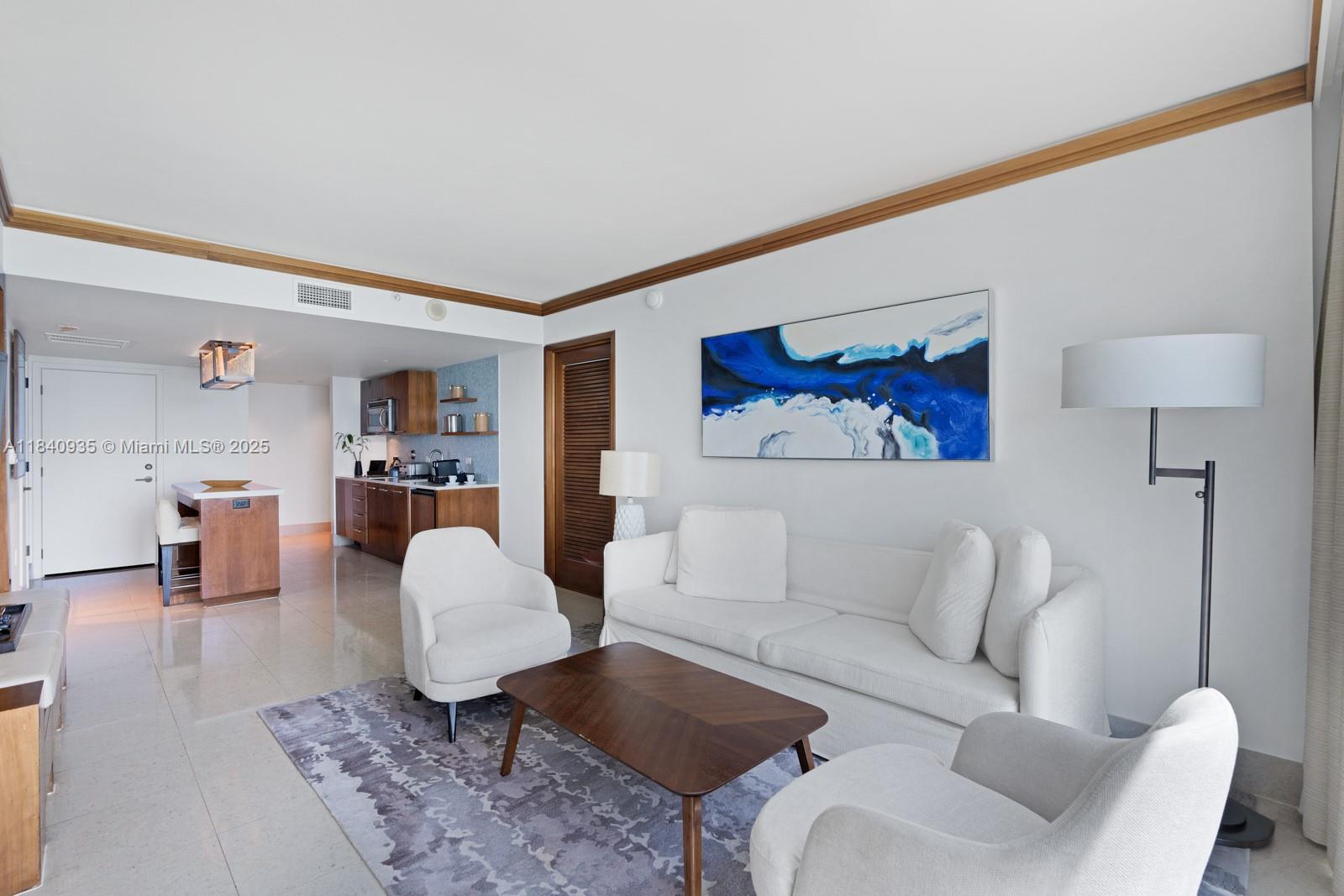 6801 Collins Avenue, Unit 705 Miami Beach, FL 33141 - Photo 9 of 54 a living room with furniture and wooden floor