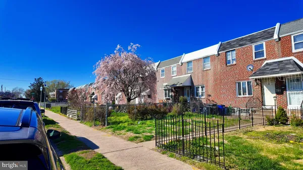 a view of a house with a yard and porch