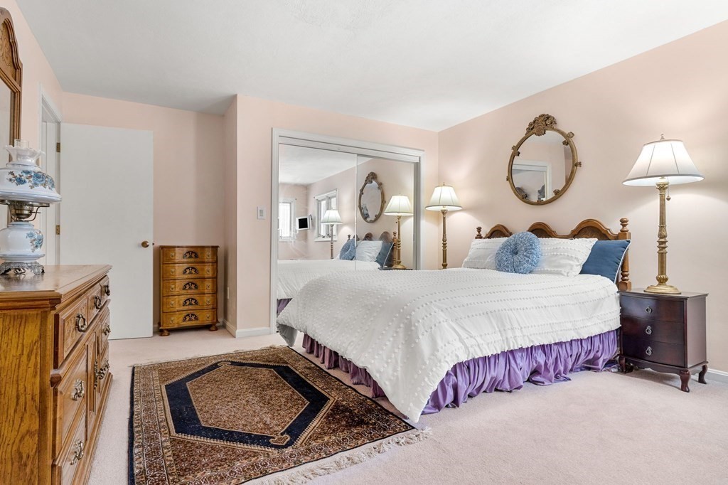 27 Rutgers Road Andover, MA 01810 - Photo 21 of 42 a bedroom with bed and a chandelier