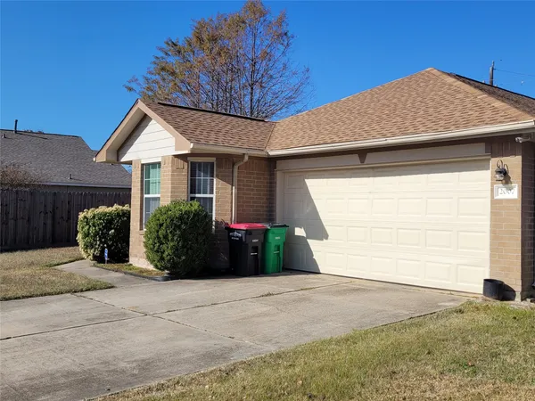 a view of a house with a yard and garage
