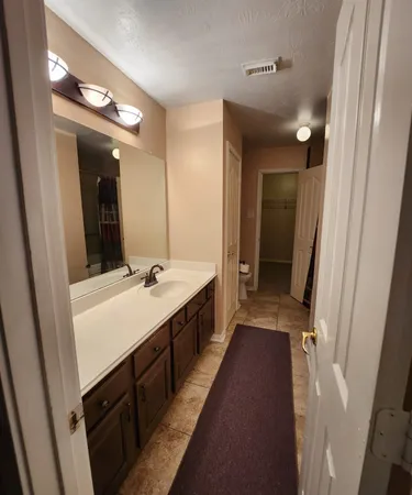 a bathroom with a double vanity sink and a mirror