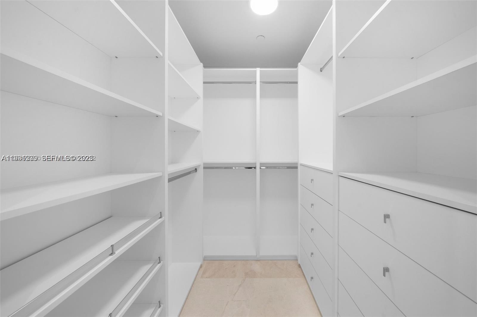 15701 Collins Avenue, Unit 2803 Sunny Isles Beach, FL 33160 - Photo 10 of 28 a view of walk in closet with empty racks