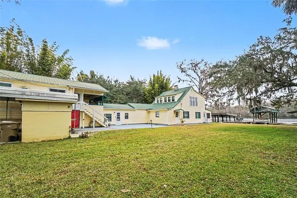a view of a house with swimming pool and a yard