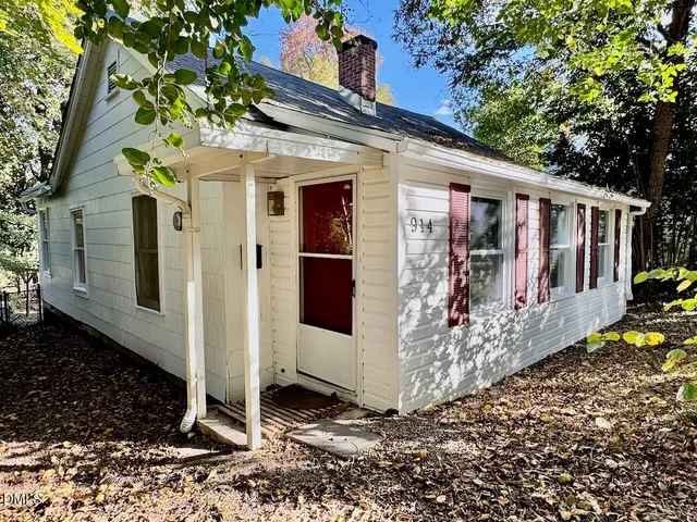 a view of a house with wooden fence