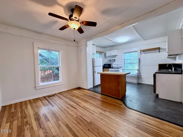 a kitchen with stainless steel appliances granite countertop cabinets wooden floors and a sink
