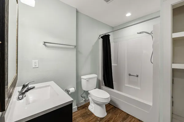 a bathroom with a sink toilet and shower