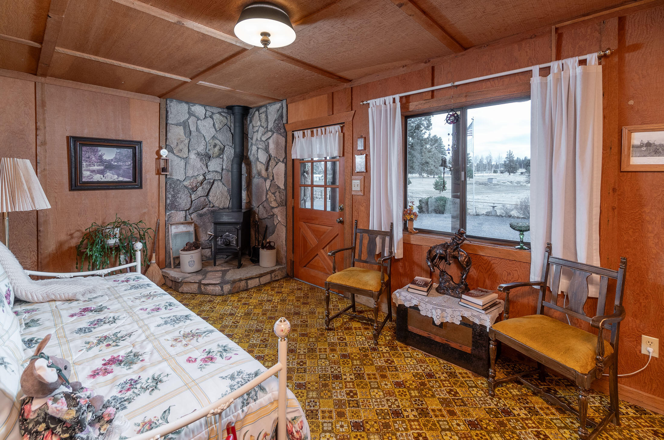 60384 Arnold Market Road Bend, OR 97702 - Photo 29 of 93 a bedroom with a bed and wooden floor