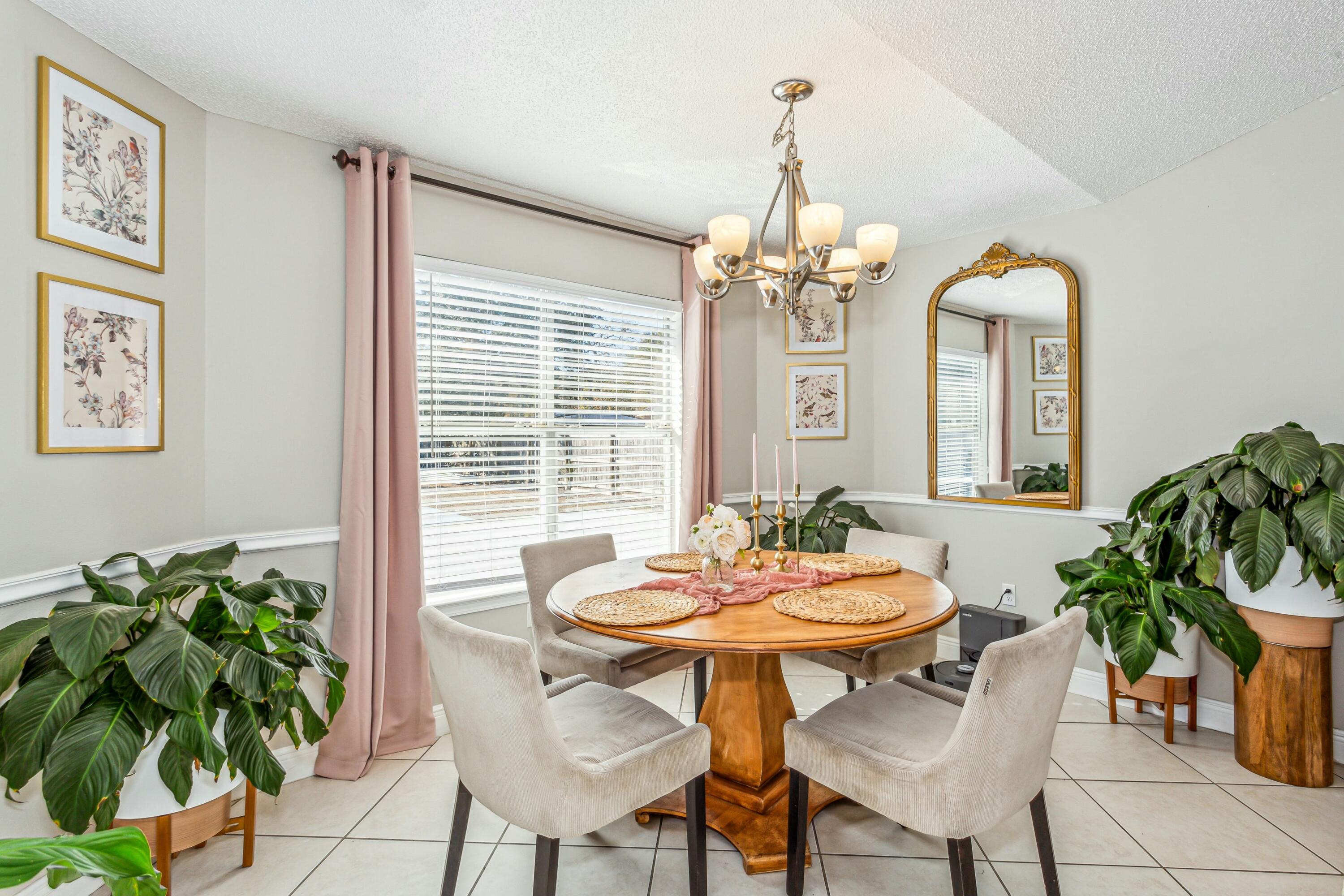 4741 Coronado Circle Crestview, FL 32539 - Photo 10 of 35 a dining room with furniture a chandelier and a rug