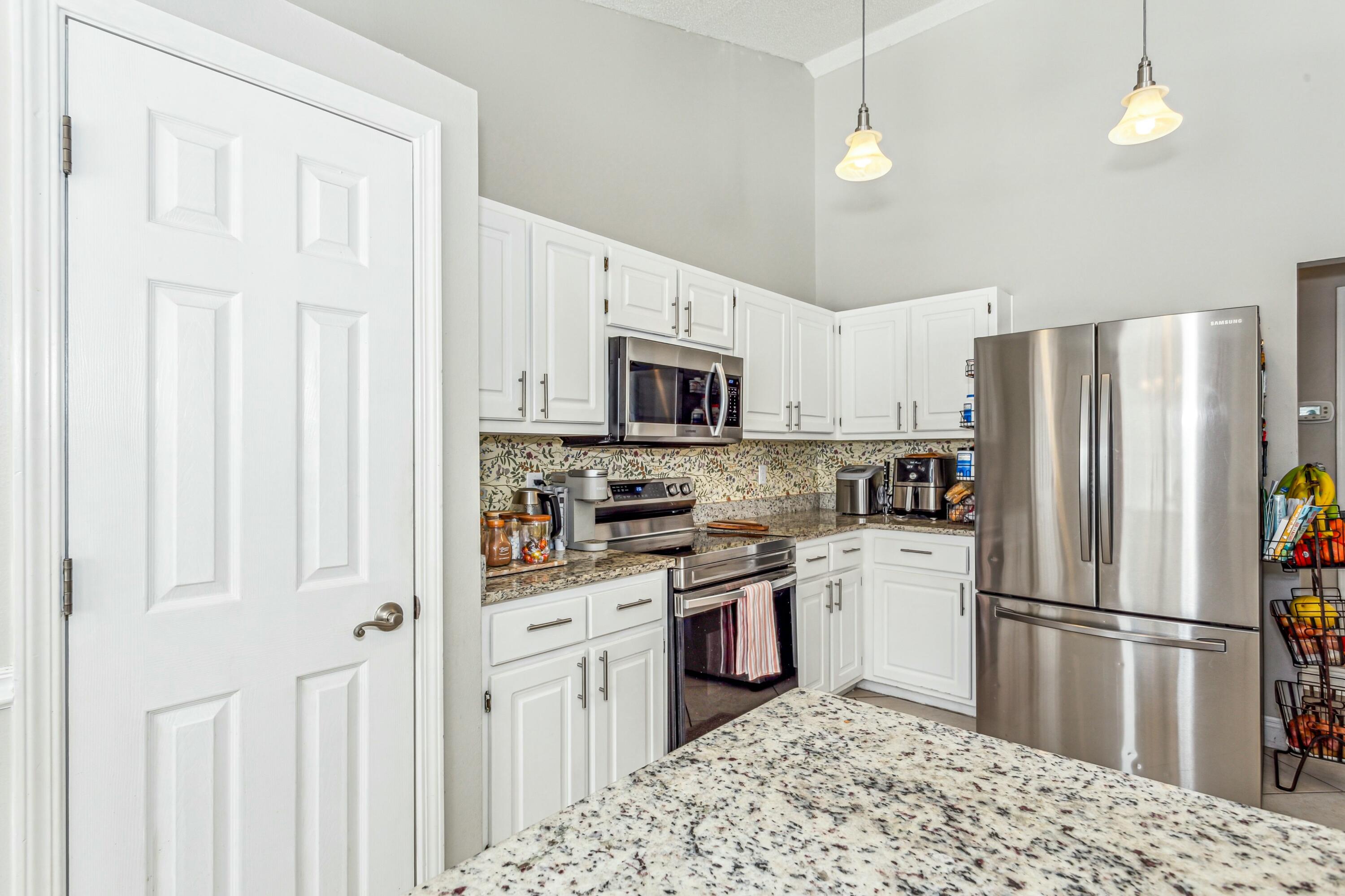 4741 Coronado Circle Crestview, FL 32539 - Photo 14 of 35 a kitchen with stainless steel appliances granite countertop a refrigerator stove and sink