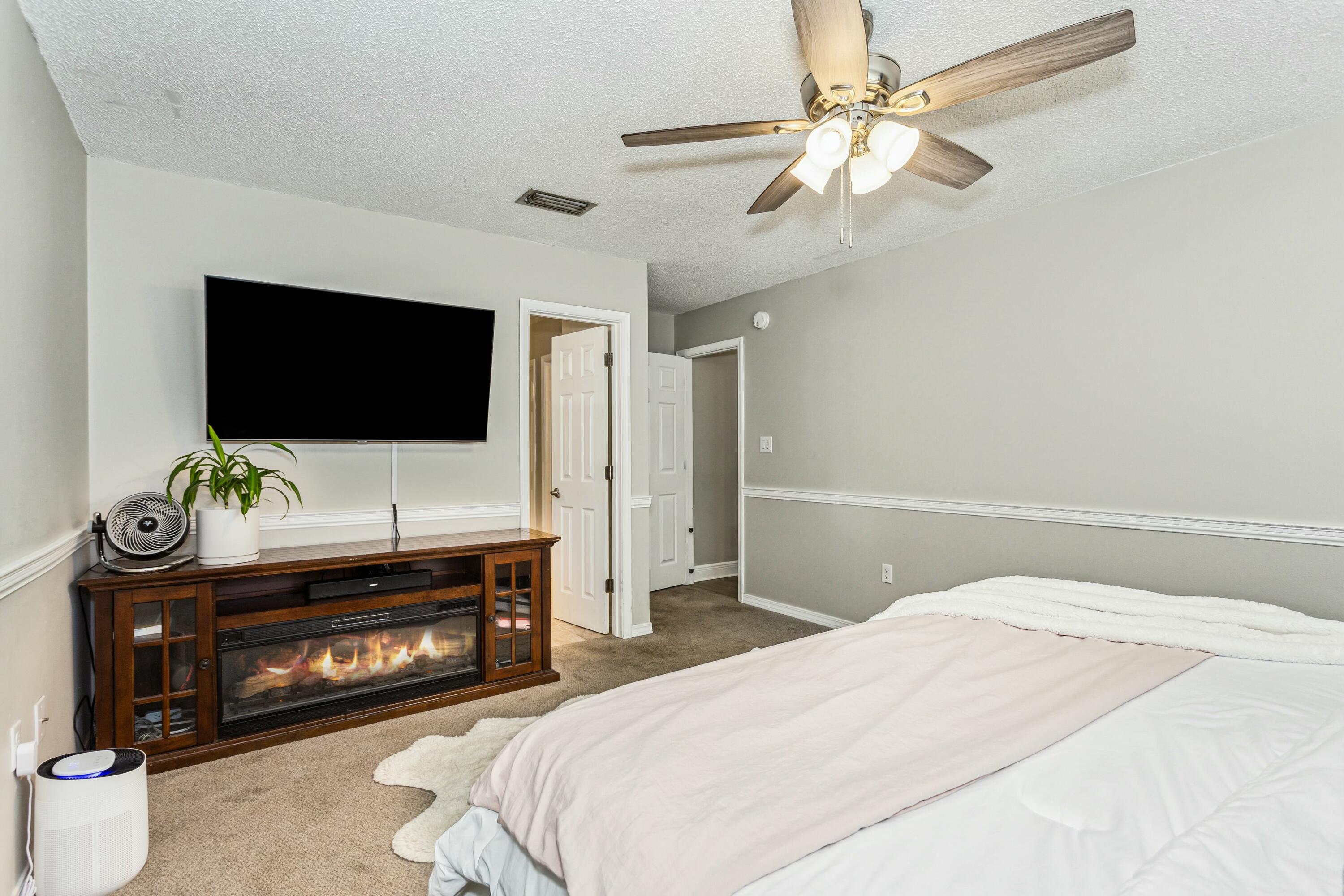 4741 Coronado Circle Crestview, FL 32539 - Photo 15 of 35 a bedroom with a bed and a flat screen tv