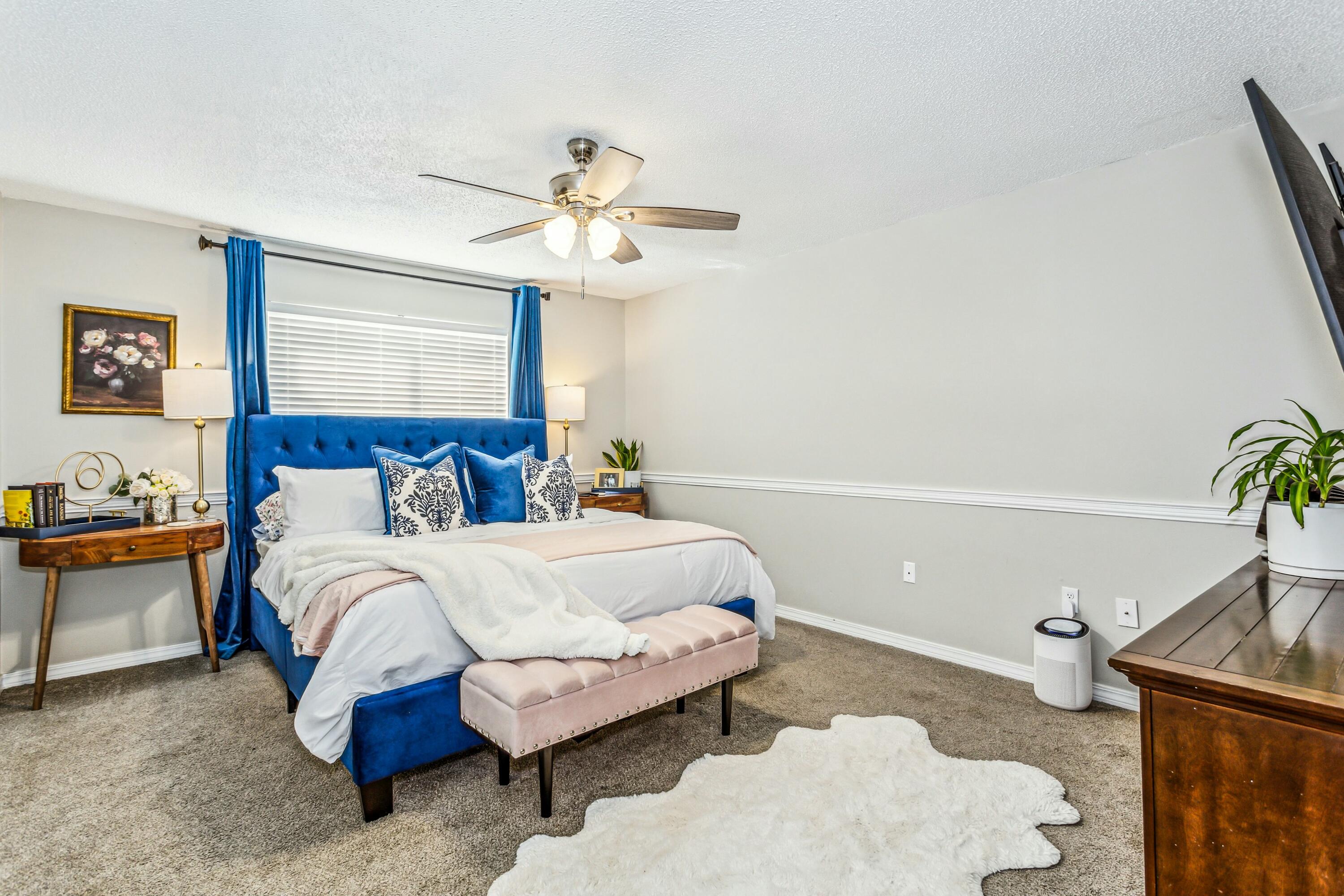 4741 Coronado Circle Crestview, FL 32539 - Photo 16 of 35 a spacious bedroom with a bed and a chandelier