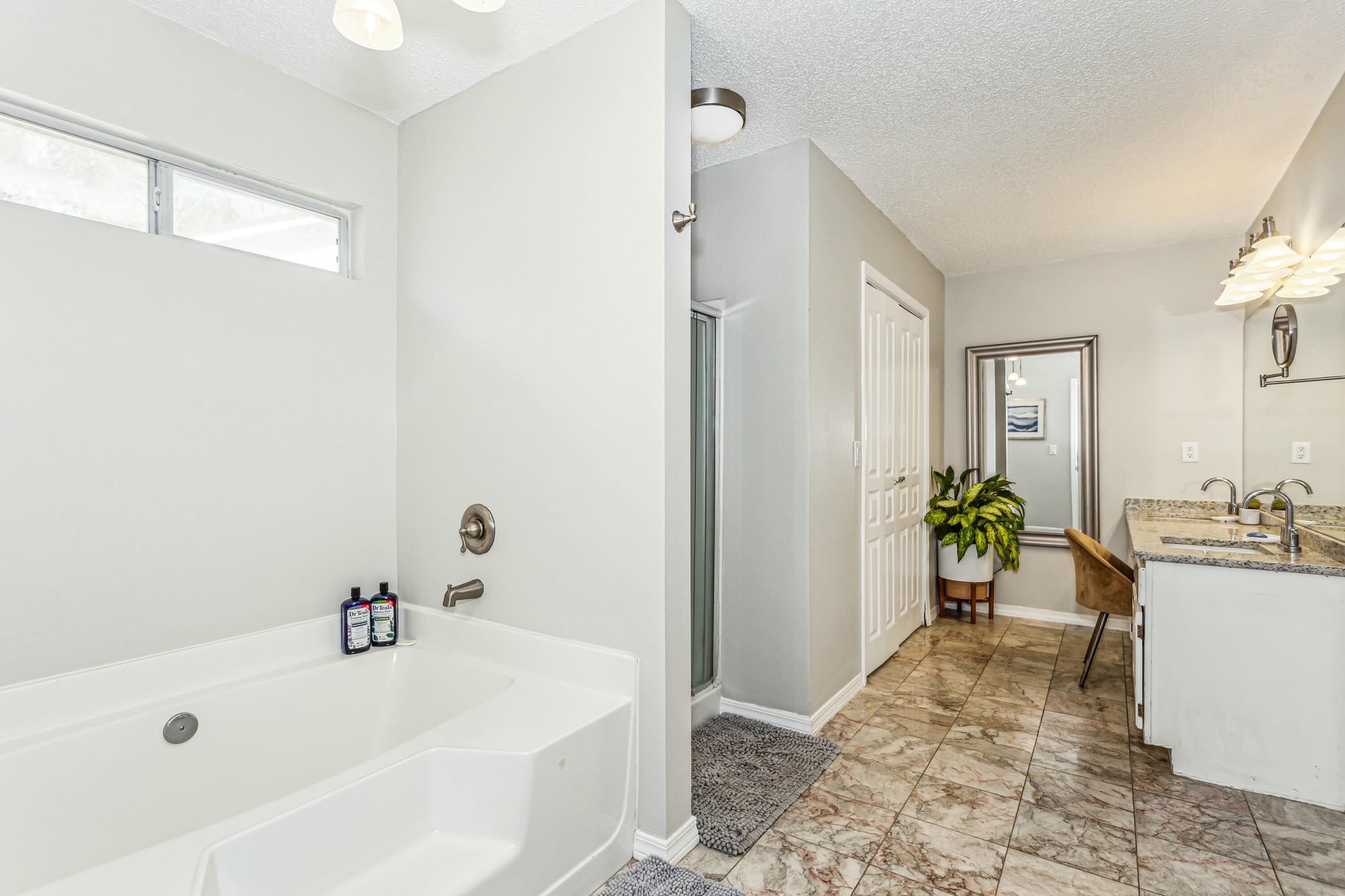 4741 Coronado Circle Crestview, FL 32539 - Photo 17 of 35 a spacious bathroom with a tub a sink and a mirror