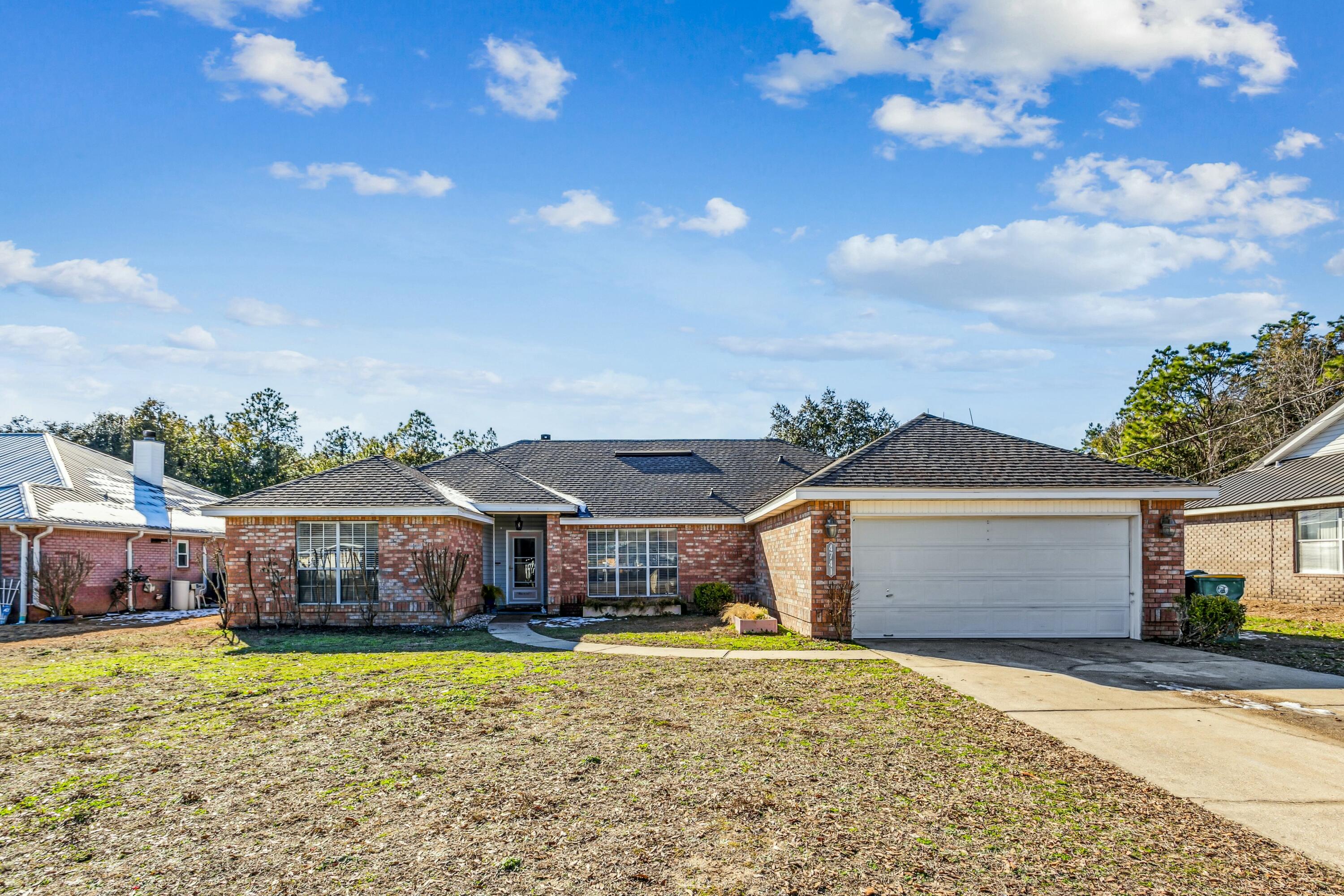 4741 Coronado Circle Crestview, FL 32539 - Photo 2 of 35 a front view of a house with a garden