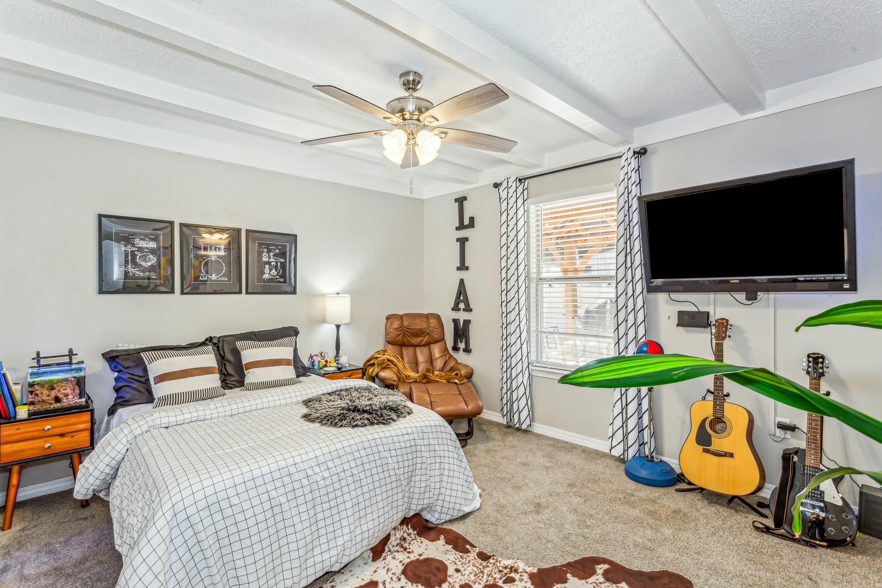 4741 Coronado Circle Crestview, FL 32539 - Photo 26 of 35 a bedroom with bed a flat tv screen and a chandelier
