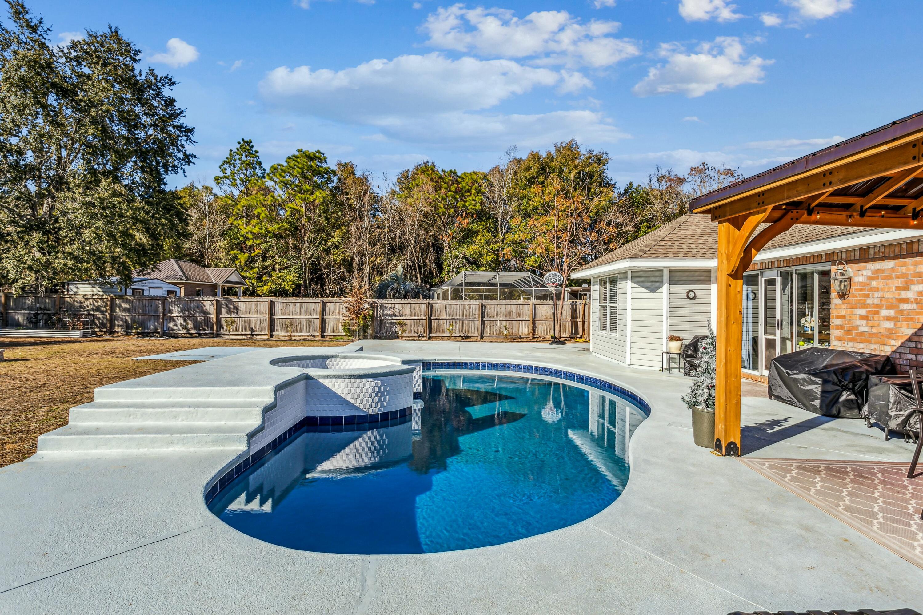 4741 Coronado Circle Crestview, FL 32539 - Photo 30 of 35 a view of a swimming pool with a lounge chair