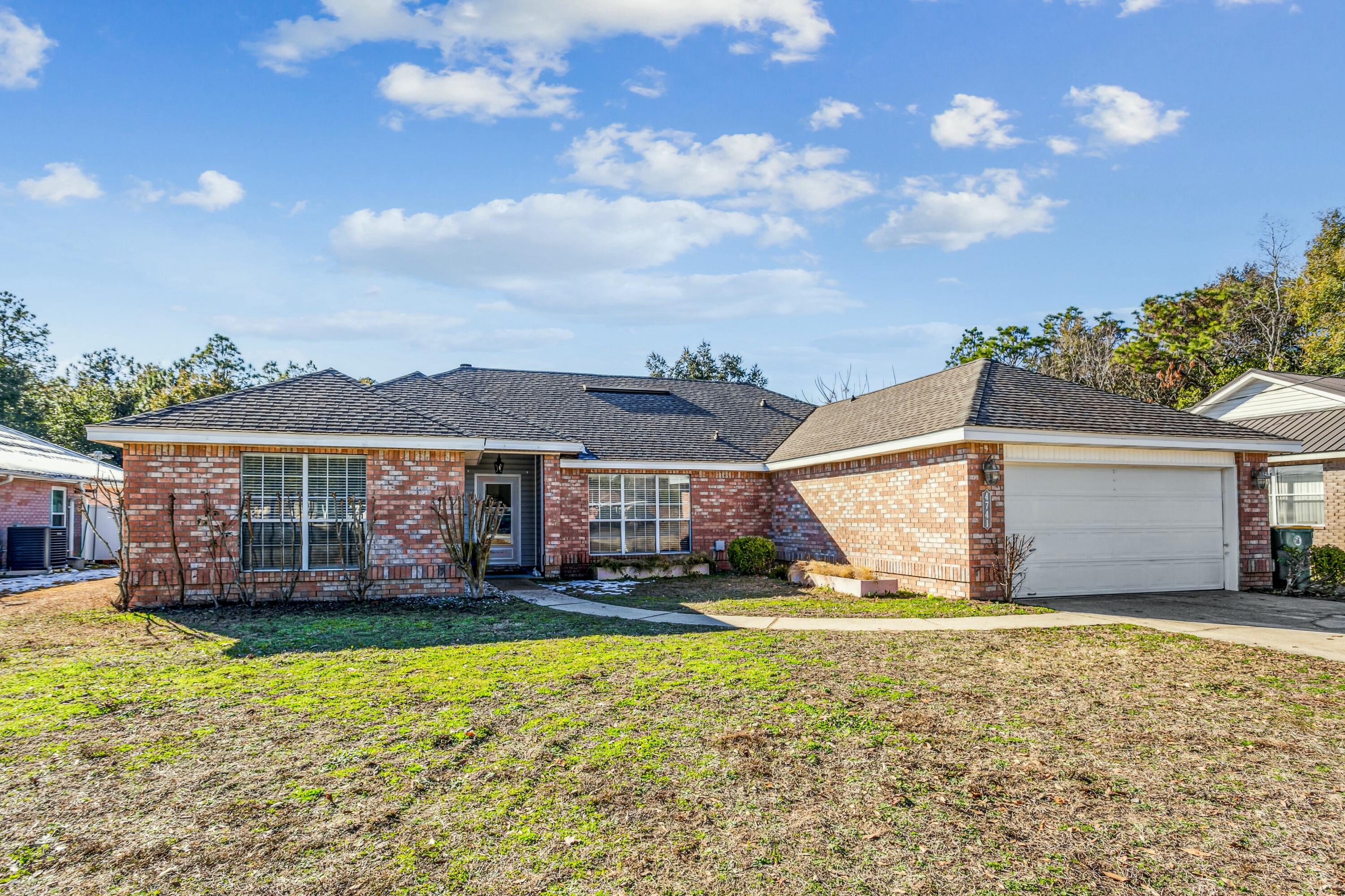 4741 Coronado Circle Crestview, FL 32539 - Photo 33 of 35 a front view of a house with a yard and potted plants
