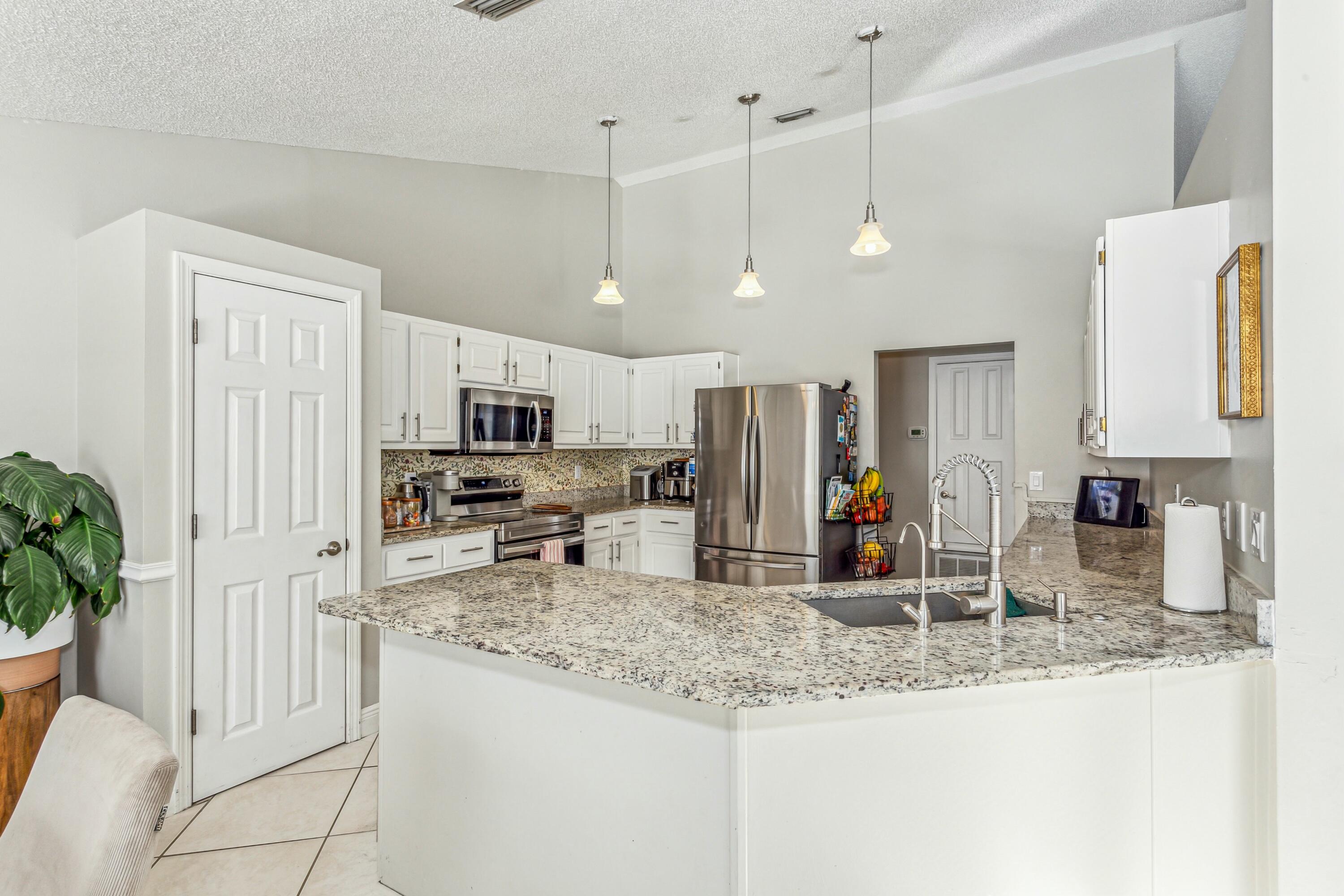 4741 Coronado Circle Crestview, FL 32539 - Photo 6 of 35 a kitchen with stainless steel appliances granite countertop a sink refrigerator and cabinets