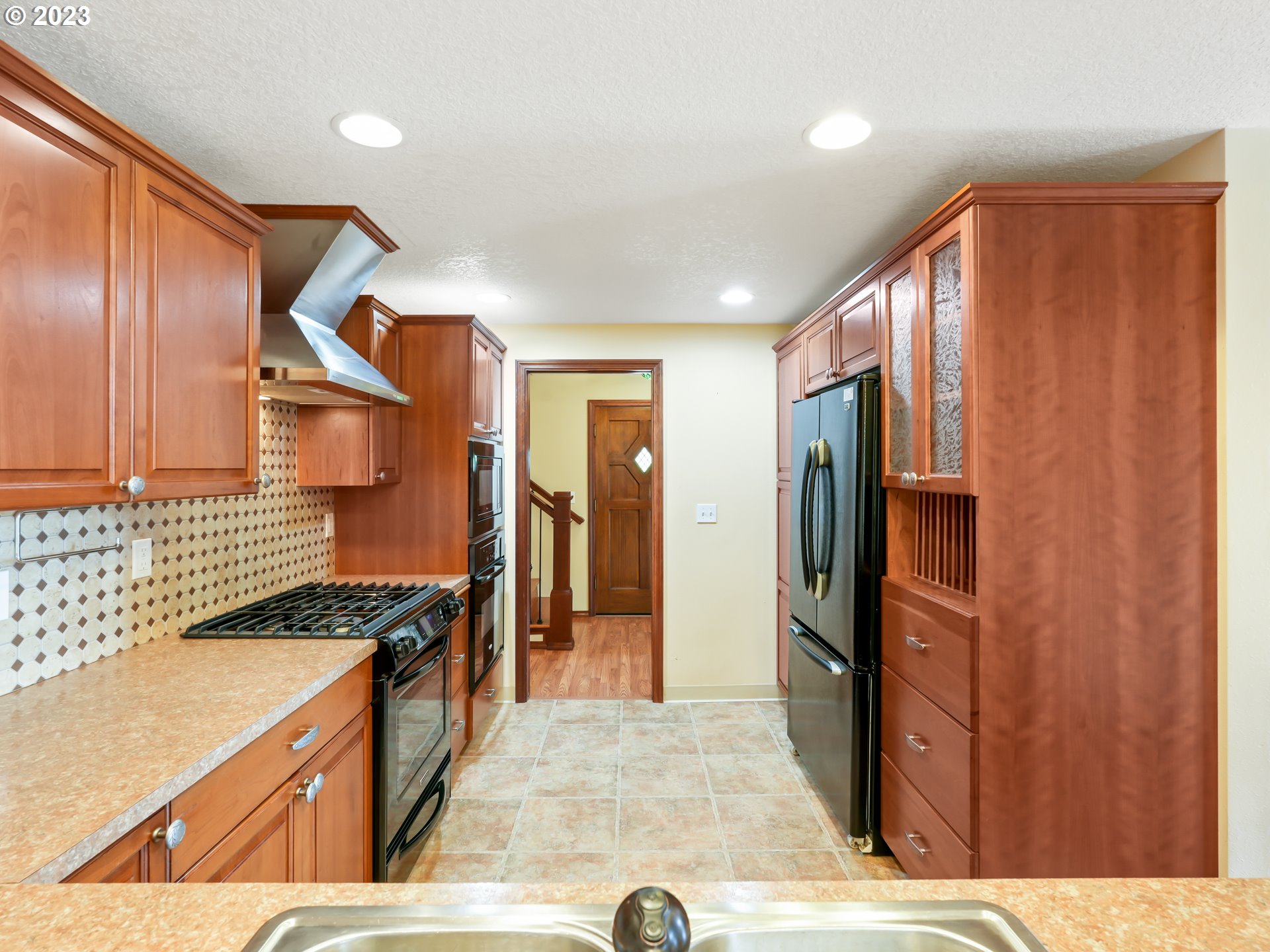 18320 Ross Avenue Sandy, OR 97055 - Photo 11 of 48 a kitchen with stainless steel appliances granite countertop a refrigerator and a stove