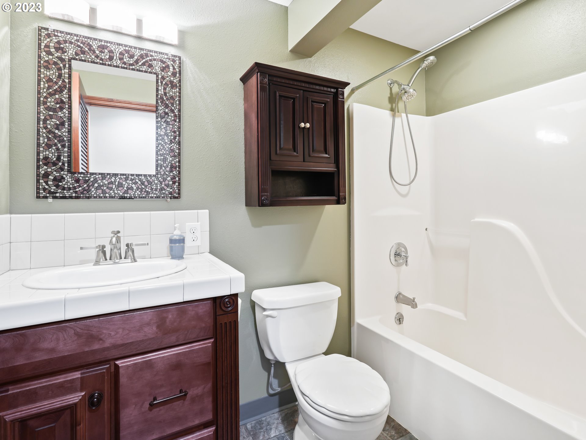 18320 Ross Avenue Sandy, OR 97055 - Photo 13 of 48 a bathroom with a toilet a sink a mirror a vanity and shower