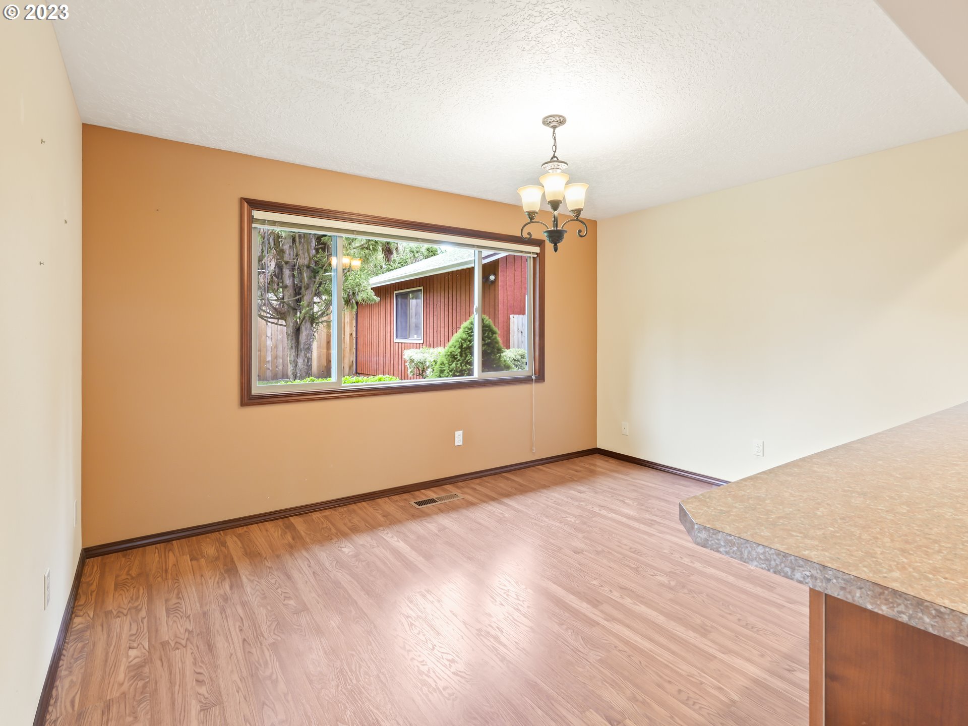 18320 Ross Avenue Sandy, OR 97055 - Photo 6 of 48 a view of an empty room with a window and wooden floor