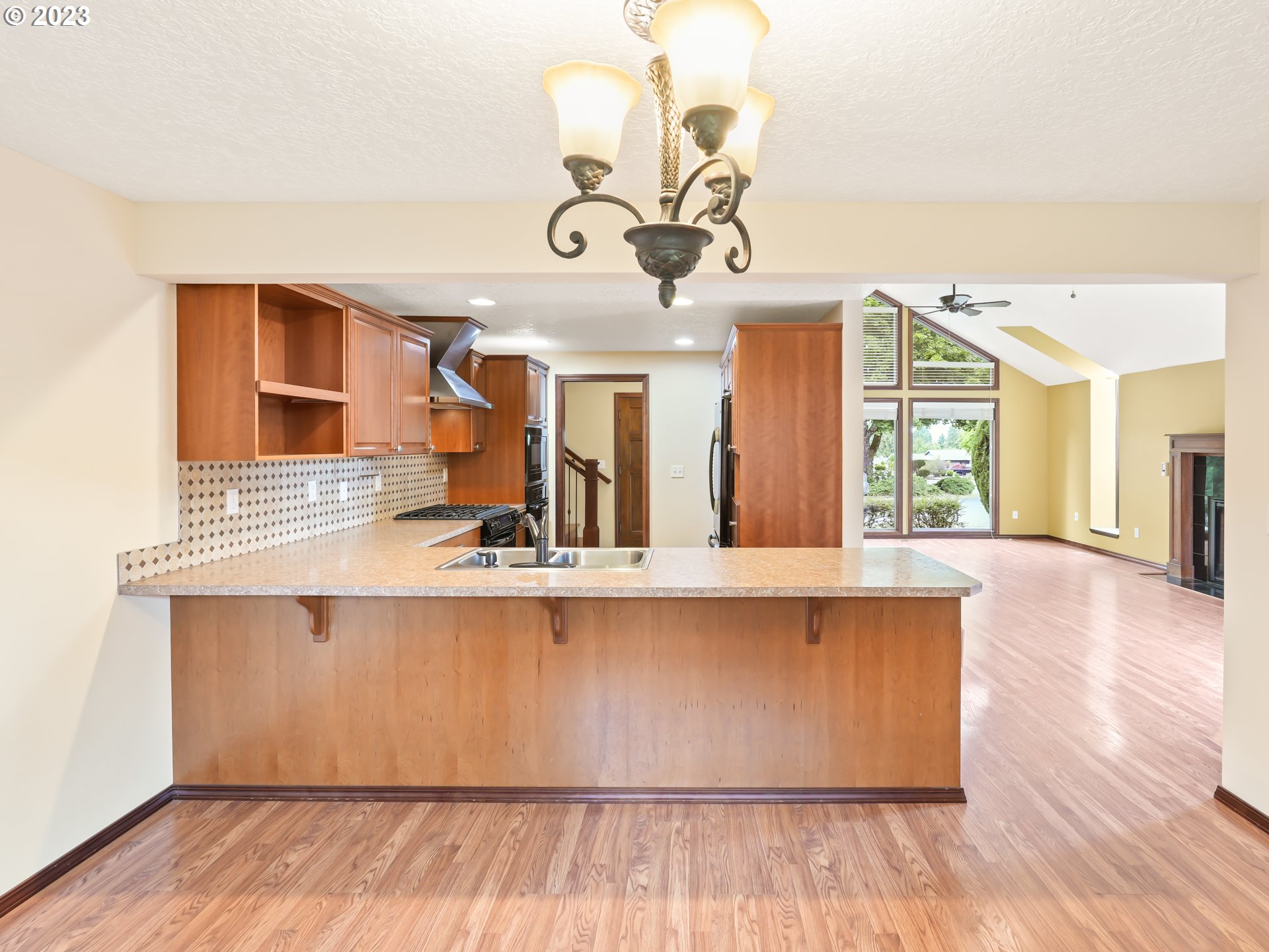 18320 Ross Avenue Sandy, OR 97055 - Photo 7 of 48 a view of a living room and kitchen with wooden floor
