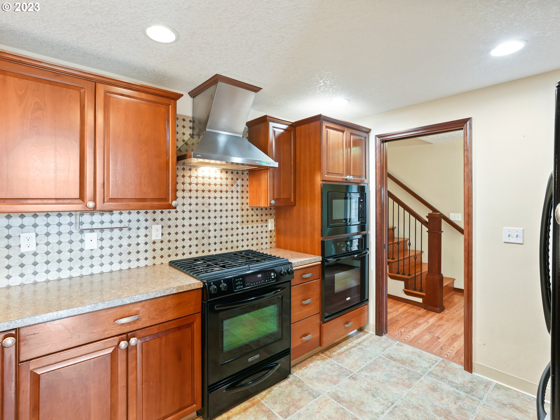 18320 Ross Avenue Sandy, OR 97055 - Photo 8 of 48 a kitchen with stainless steel appliances granite countertop a stove and a refrigerator