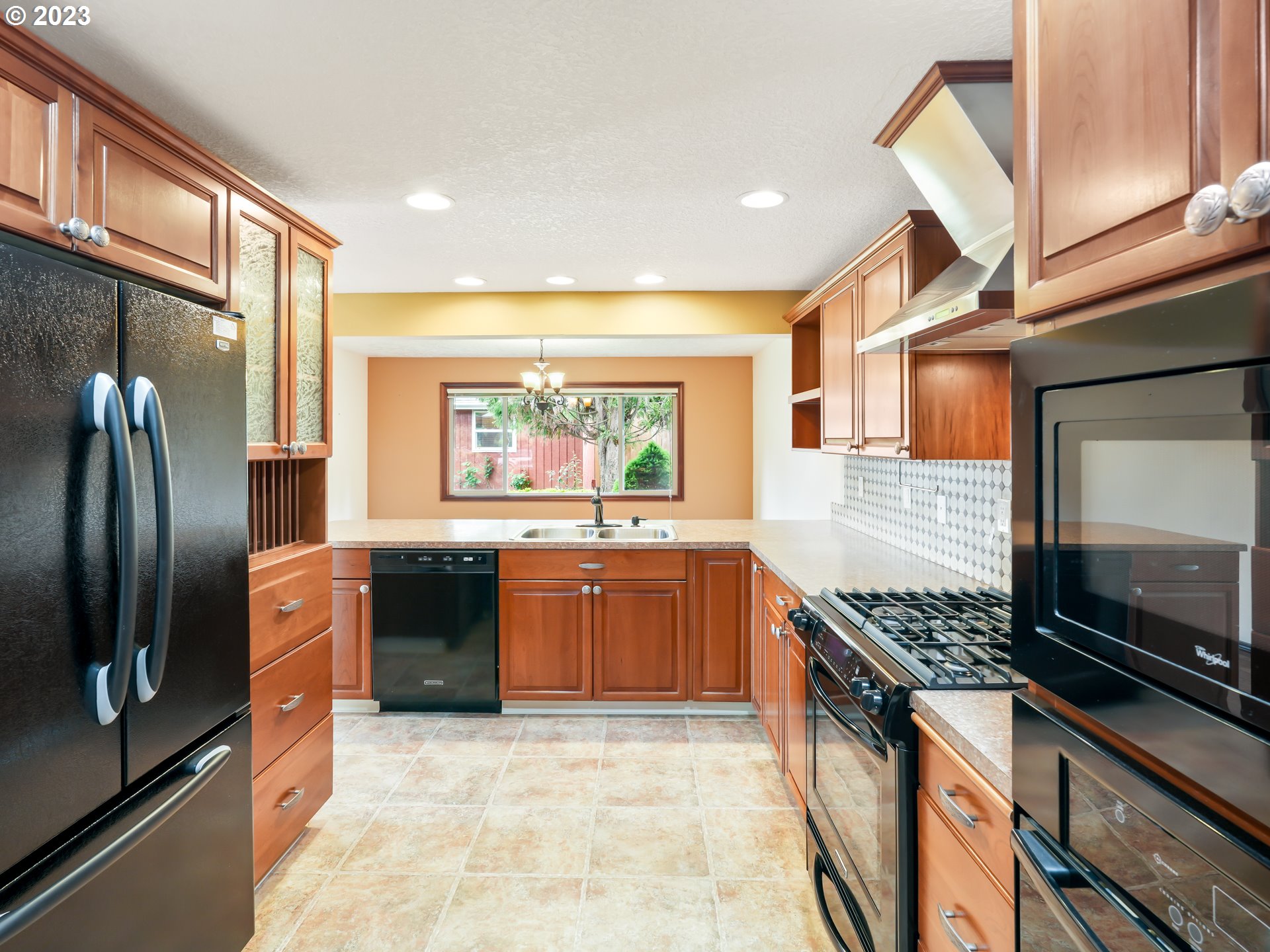 18320 Ross Avenue Sandy, OR 97055 - Photo 9 of 48 a kitchen with stainless steel appliances granite countertop a stove a sink and a refrigerator