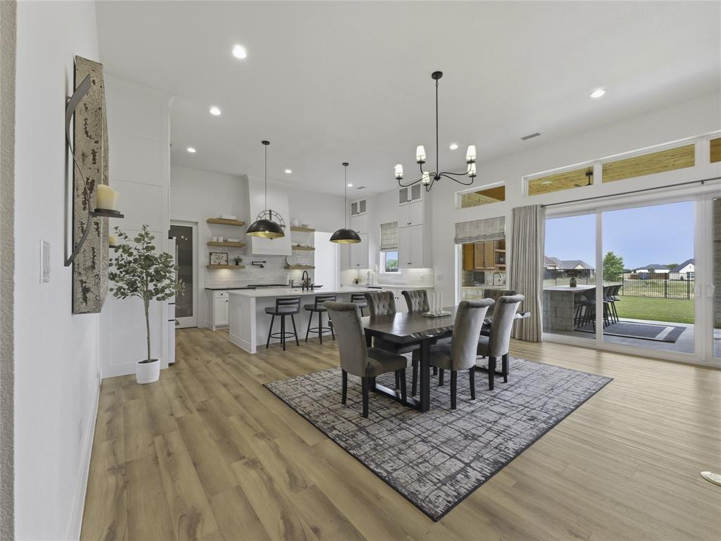 4211 Azalea Way Midlothian, TX 76065 - Photo 10 of 39 Open-concept living space featuring wood-finish flooring, recessed lighting, and a chandelier