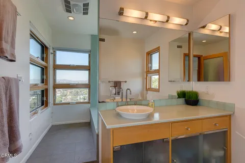 a bathroom with a sink a large mirror and vanity