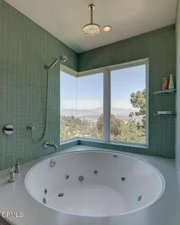 a bathroom with a bathtub and shower