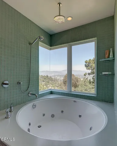 a bathroom with a bathtub and shower