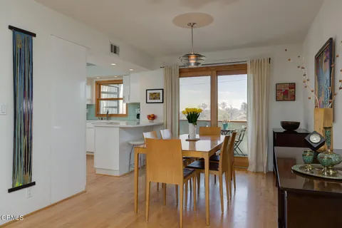 a view of a dining room with furniture window and wooden floor