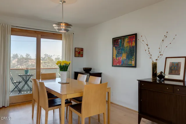 a view of a dining room with furniture window and wooden floor