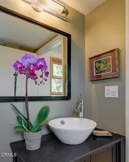 a bathroom with a sink mirror and vanity